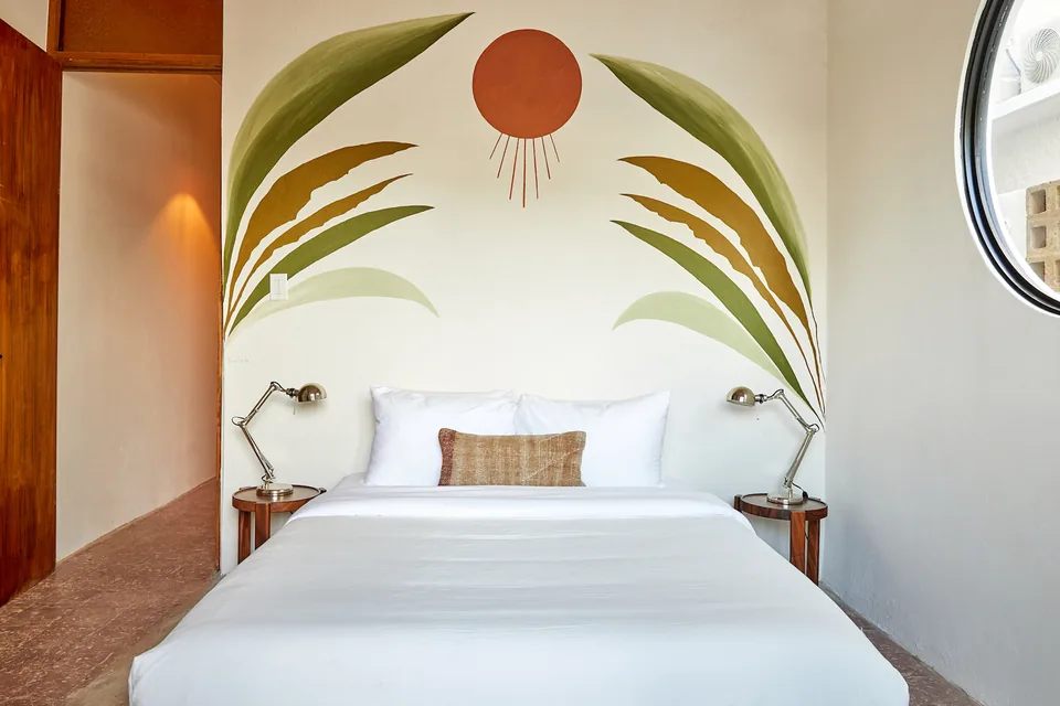 Queen bedroom with warm colors in APT 3