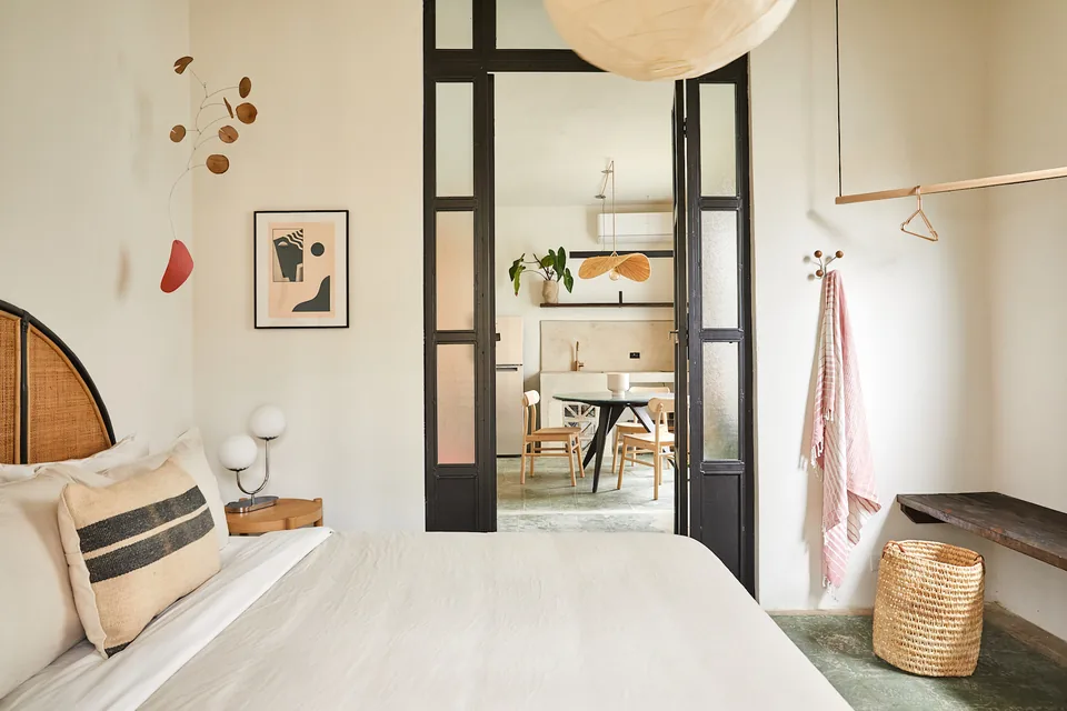 Queen bedroom with natural accents in APT 4