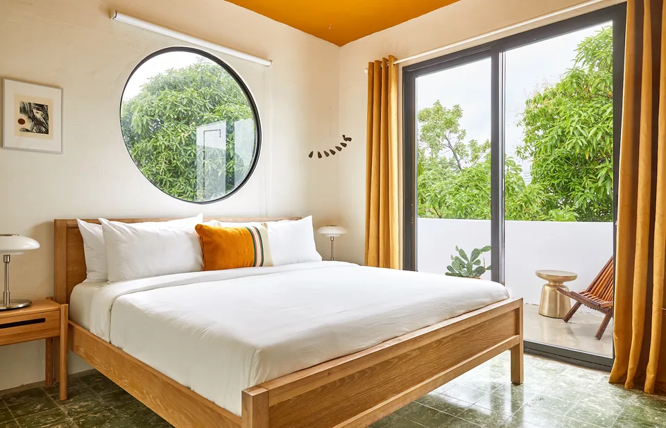 Light-filled bedroom with natural materials in APT 5