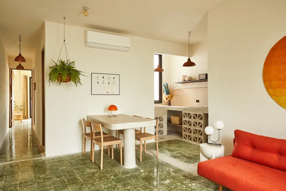 Open-plan living room, kitchen and dining area in APT 6