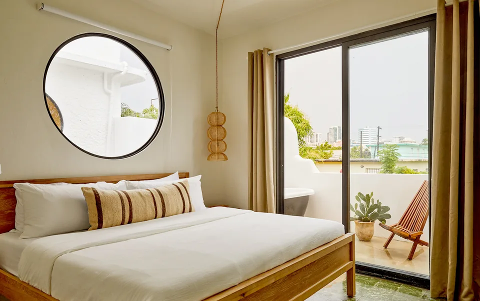 Bedroom with light walls and natural materials in APT 7