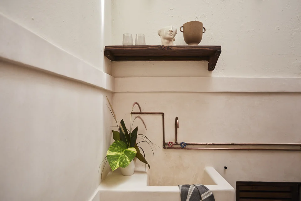 A small preparation counter and copper faucet in JA1’s skylit kitchenette