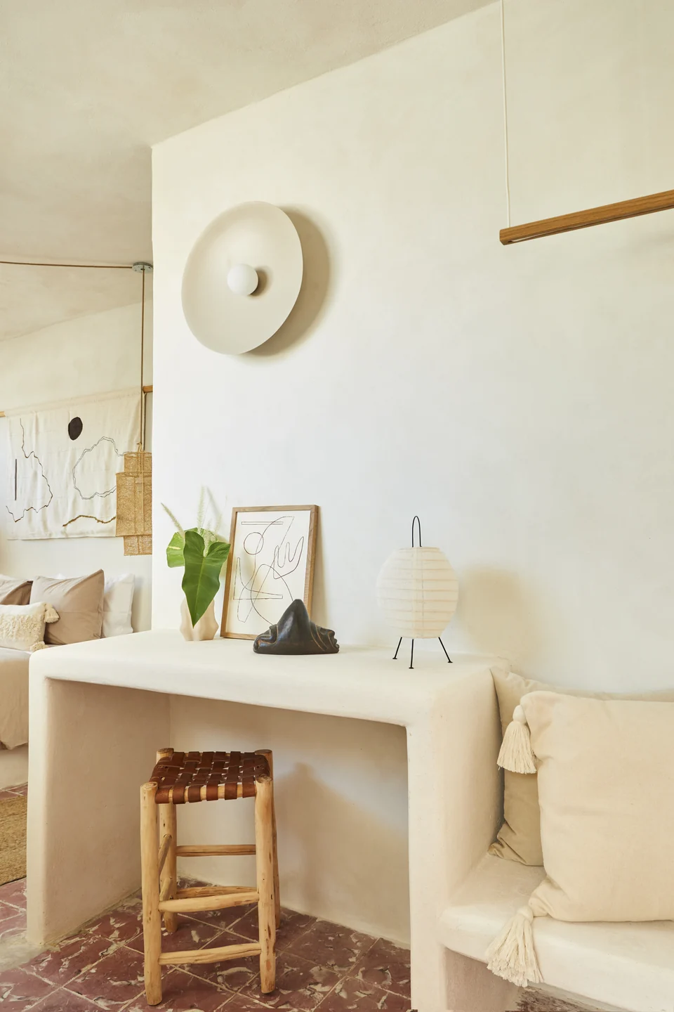 A concrete desk, woven chair and fiber pendant in JA2