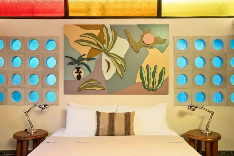A guest suite at Dreamcatcher, the flagship boutique hotel of Dreamers Welcome, with an outdoor seating area beyond the doors.