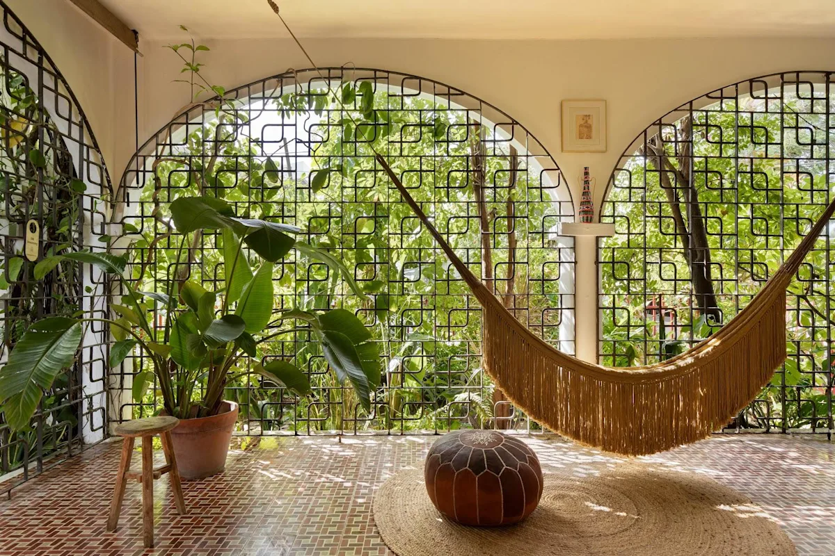 A hammock slung in a planted outdoor corner at Dreamcatcher, the flagship boutique hotel of Dreamers Welcome, in Ocean Park.