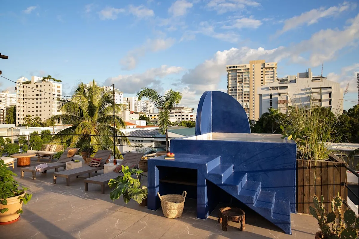 A rooftop terrace at Maru by DW in Condado, looking across the neighbourhood's low-rise roofs and towers.