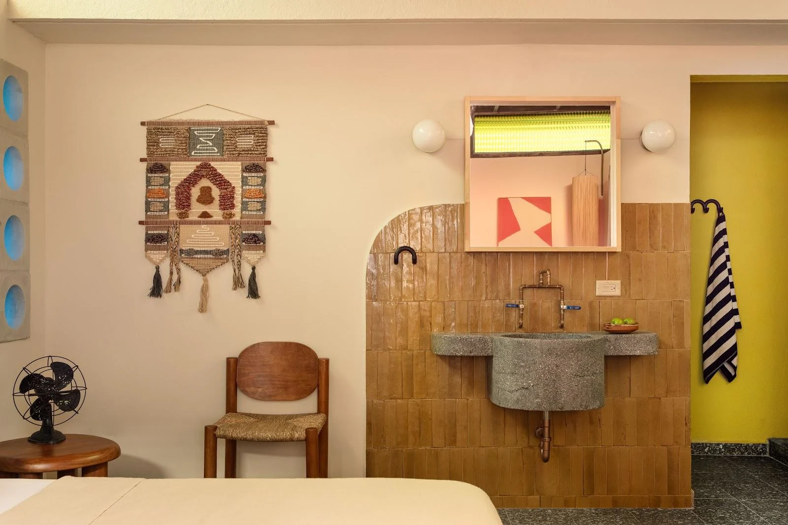 The Aya Suite at Dreamcatcher, the flagship boutique hotel of Dreamers Welcome in Ocean Park, San Juan, with its wooden vanity and arched wall.