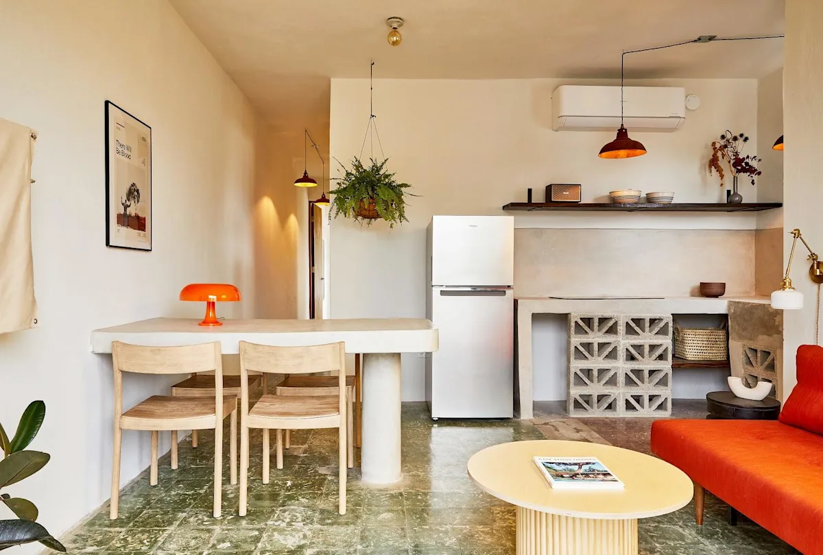 The open kitchen, dining table and living area of an apartment at APT by DW in Santurce, San Juan.