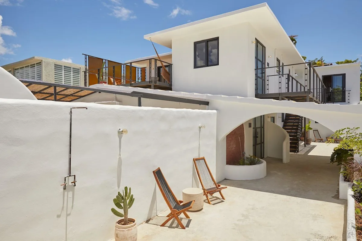 The white apartment buildings and shared terrace at Duna by DW, a Dreamers Welcome stay in San Juan.