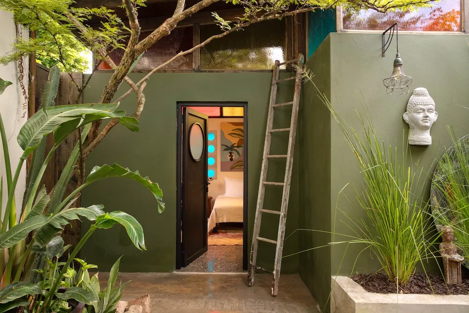 Green-walled private terrace and outdoor soaking tub at the Aya Suite