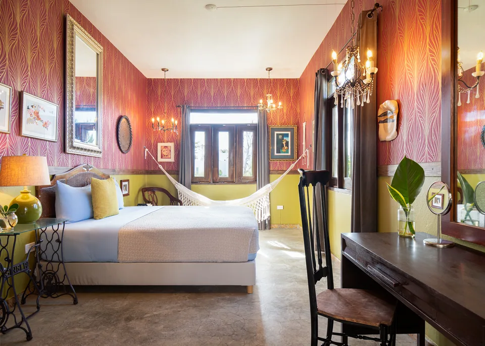 Patterned walls, curtains and a king bed in the Dreamcatcher Suite