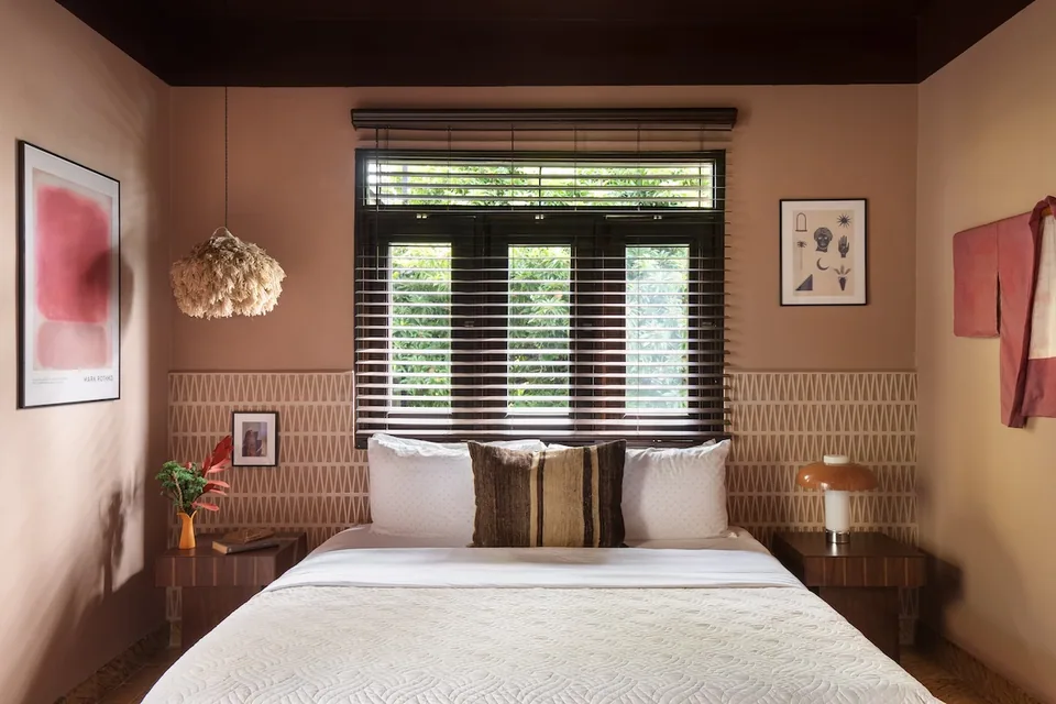 King bed and warm earthy walls in the Mio Suite