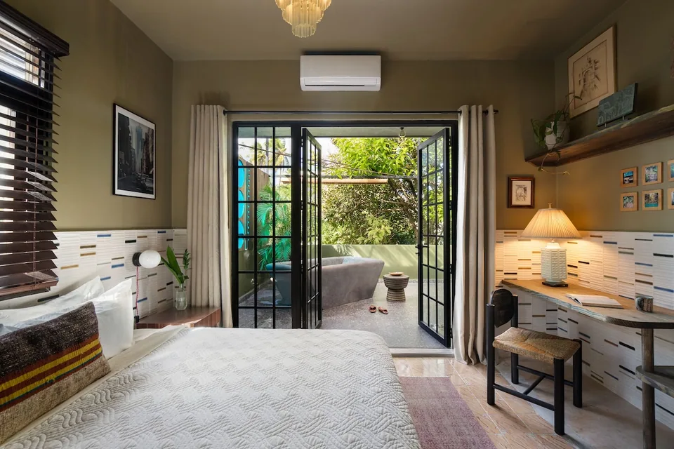 King bed and dark timber accents in the Palm Suite