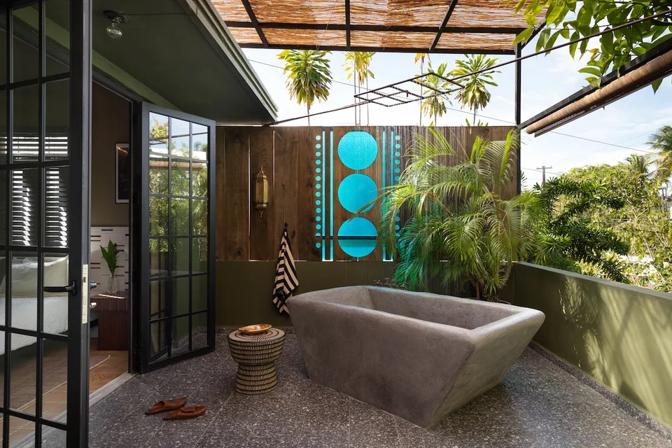 Outdoor concrete soaking tub on the Palm Suite’s planted terrace