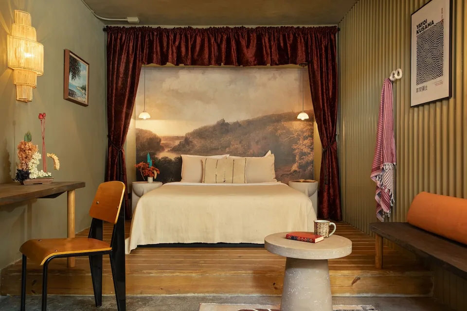 Queen bed and landscape mural in the Poet Room