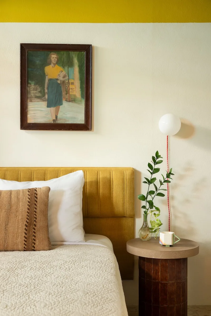 Queen bed with a golden velvet headboard in a Sanctuary-category room