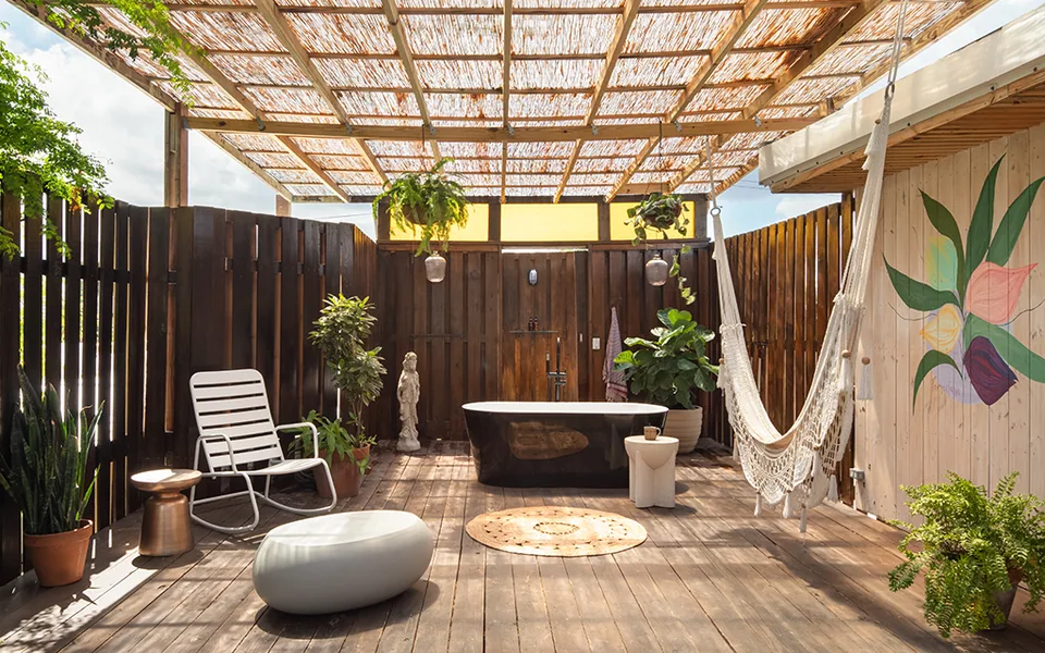 Private deck with hammock and an outdoor bath at the Tropicalia Suite