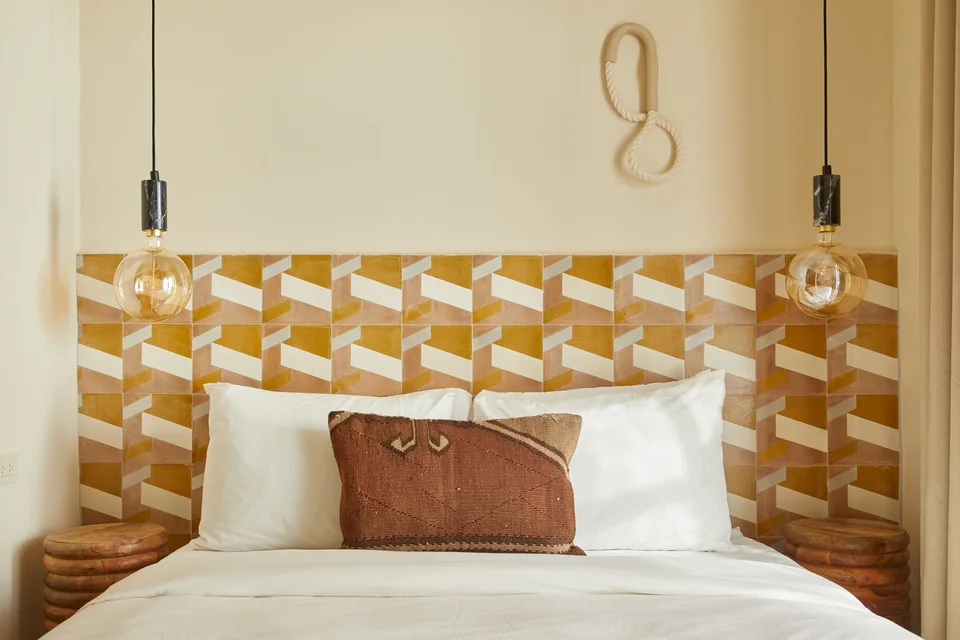 Queen bed with a warm geometric tile headboard in Drifter