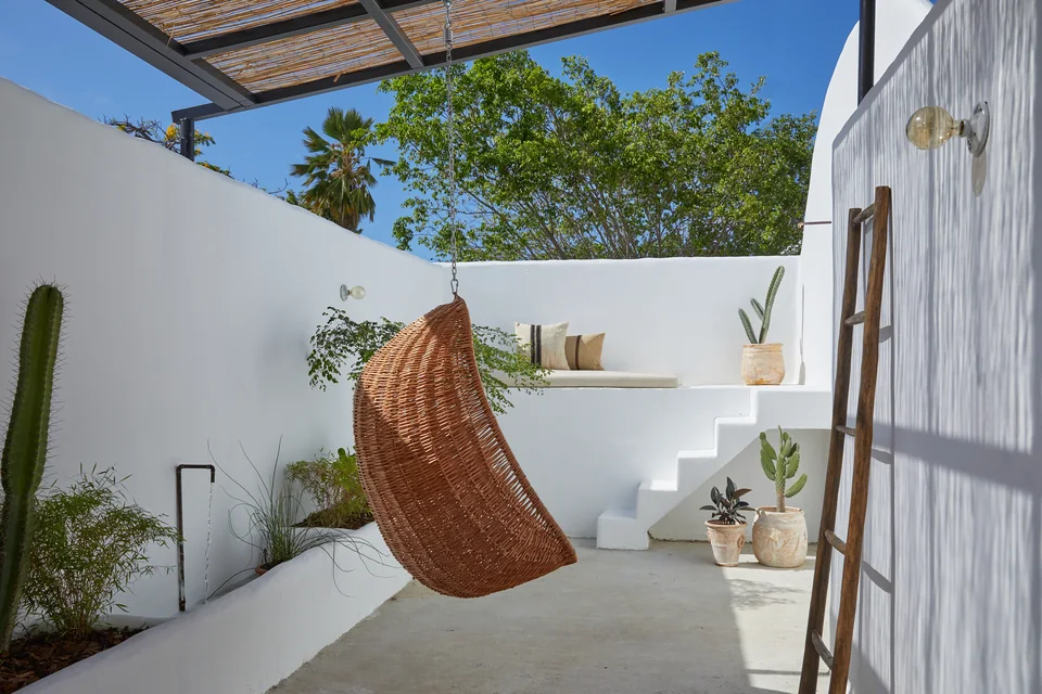 Woven hanging chair and outdoor shower on Drifter’s private terrace