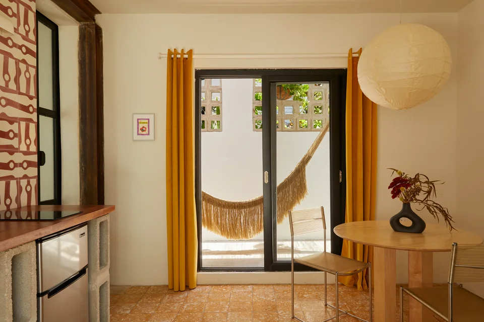 Kitchenette, dining area and hammock beyond the doors in Nomad