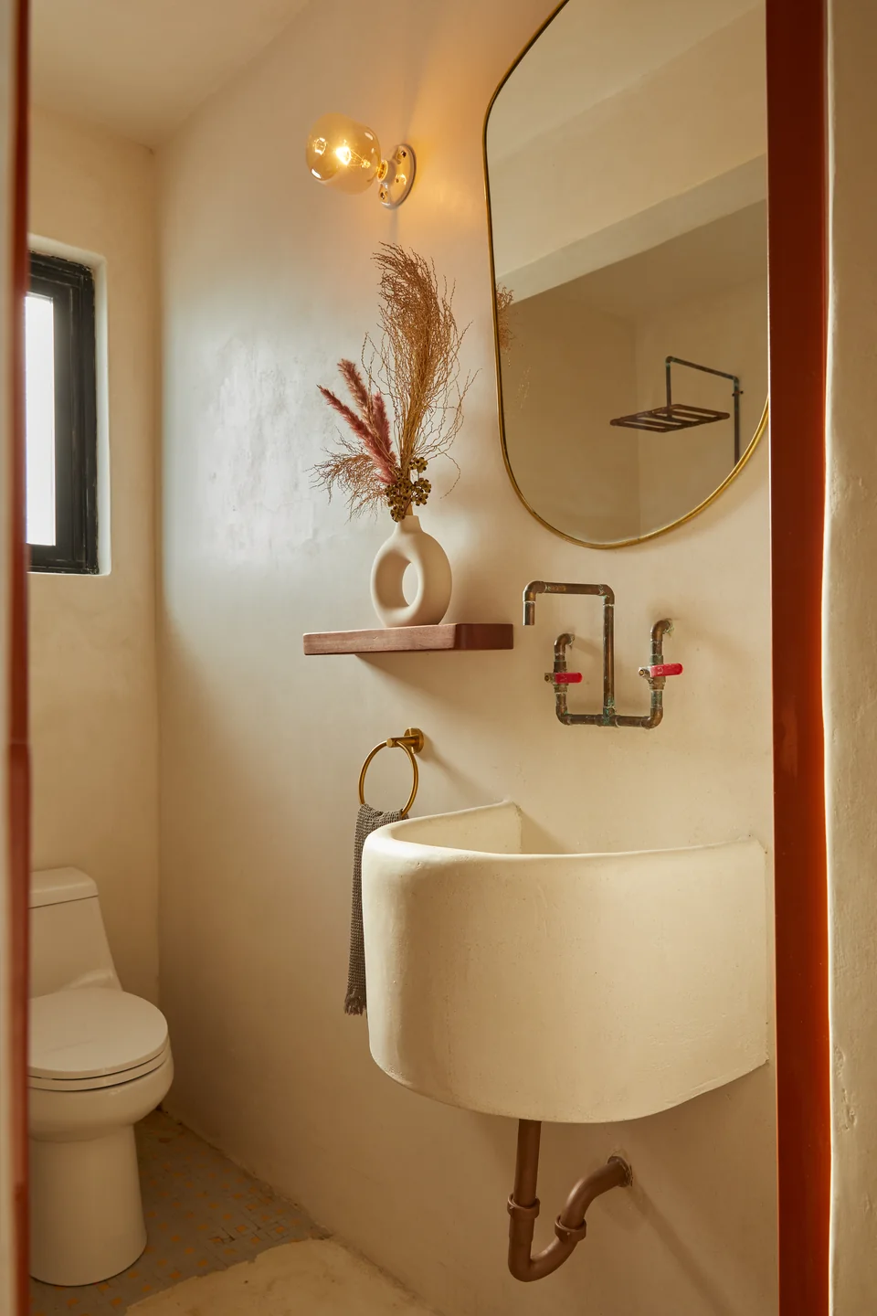 Custom washbasin and curved mirror in Poet’s bathroom