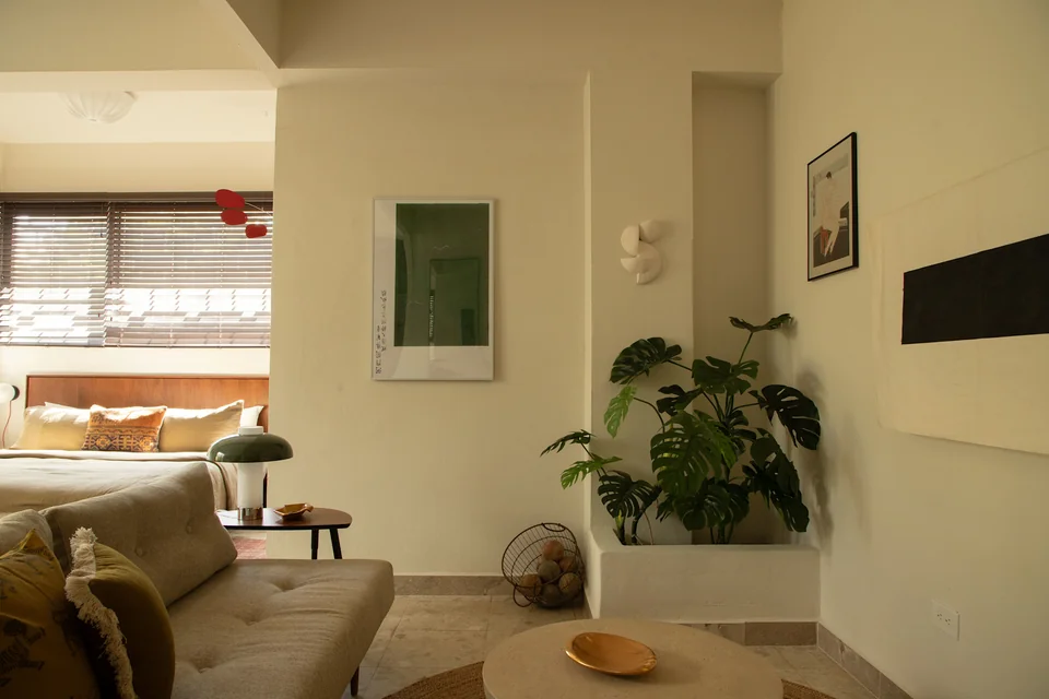 Soft seating and a king bed in AYA’s open studio