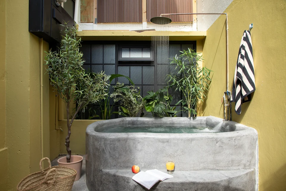Concrete outdoor soaking tub on AYA’s ochre-walled private patio