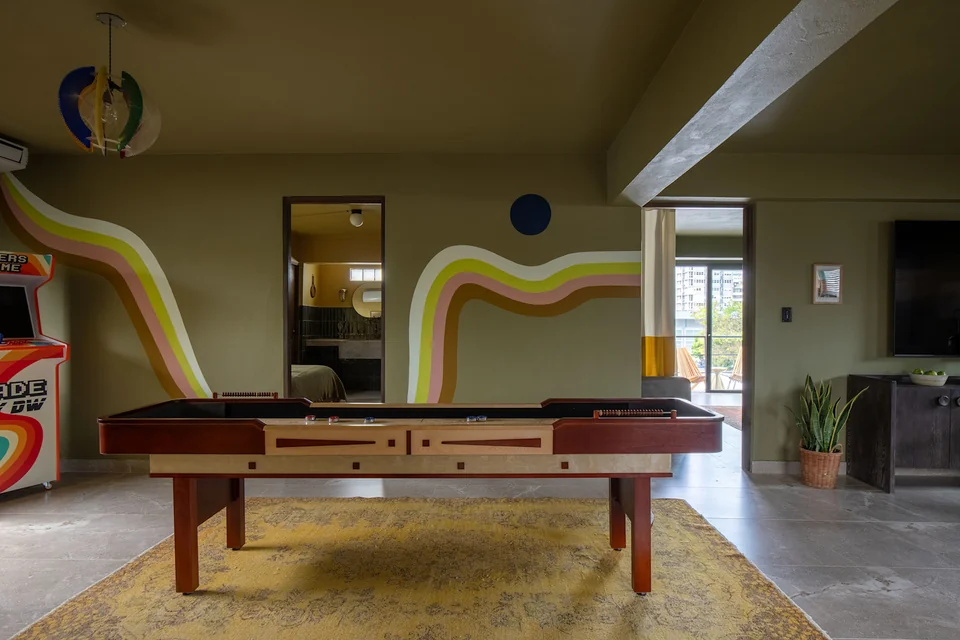 Pool table, colorful wall art and games lounge at Maru