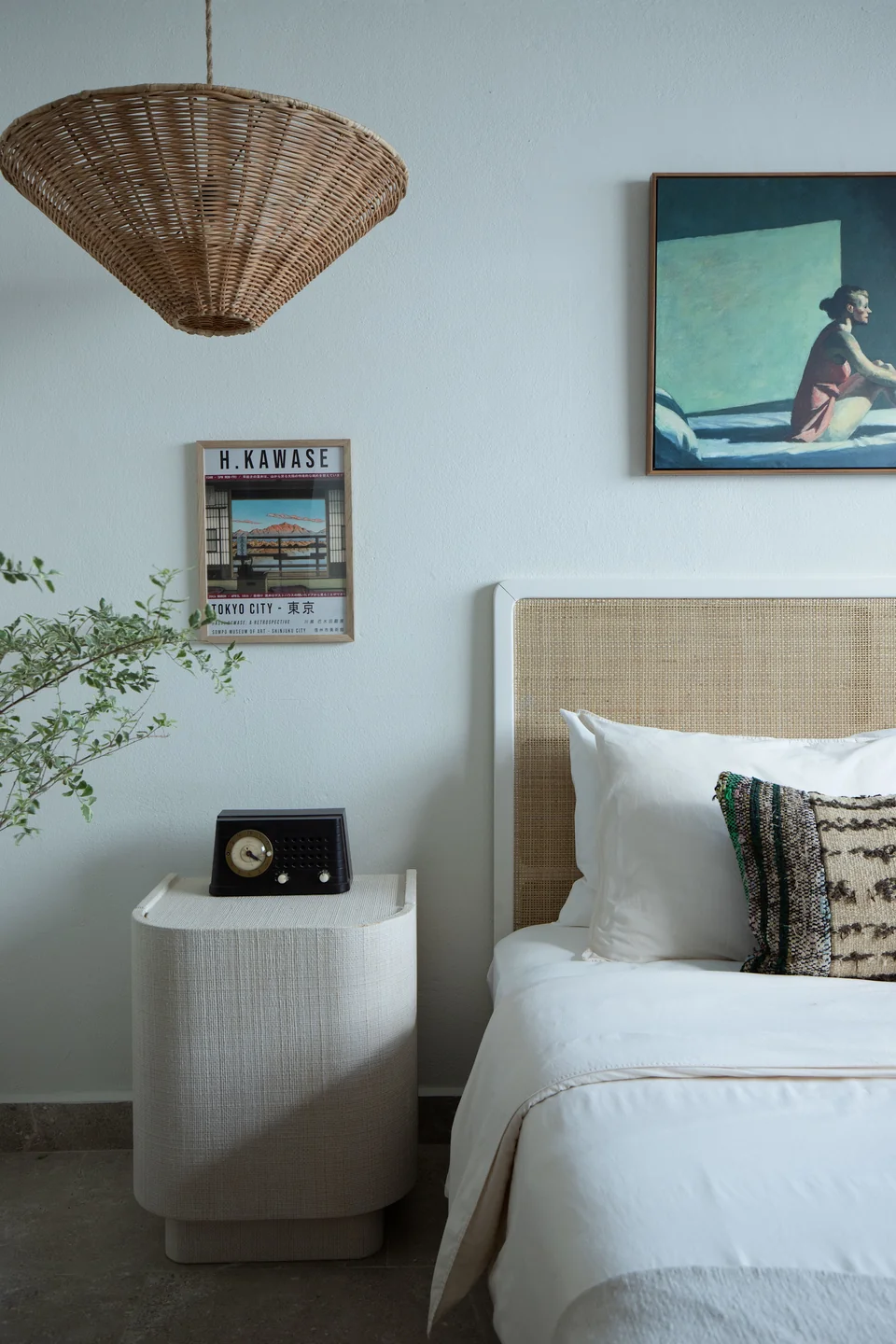 Blue-toned Maru guestroom with a bed and woven pendant light