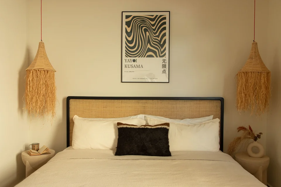 Maru guestroom with woven pendants and a botanical print