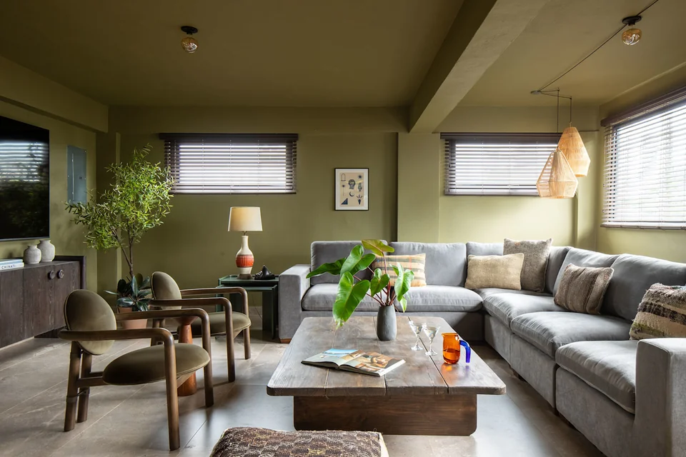 Sofas, timber accents and windows in MAO’s living room