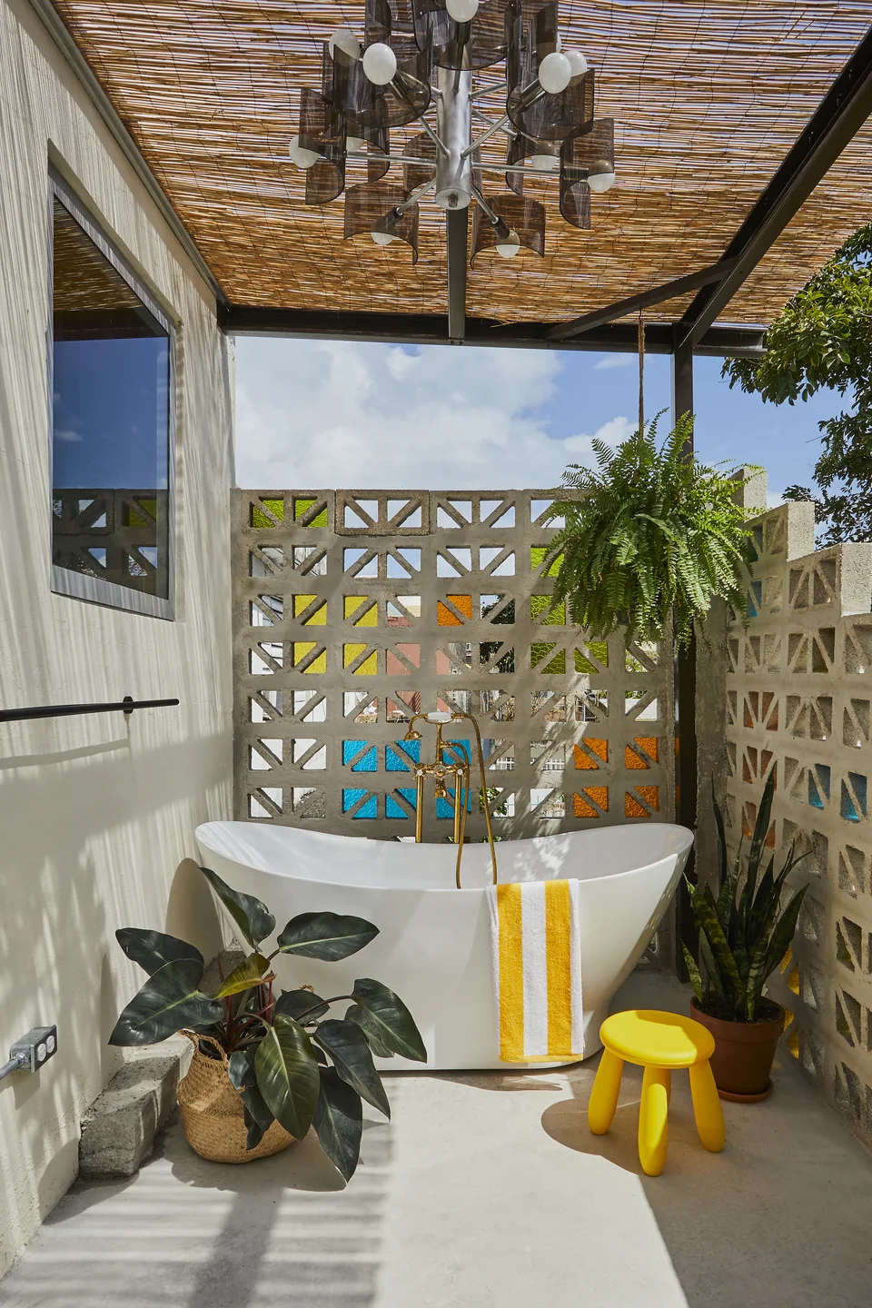 Outdoor soaking tub, plants and breeze blocks on Donna’s private terrace