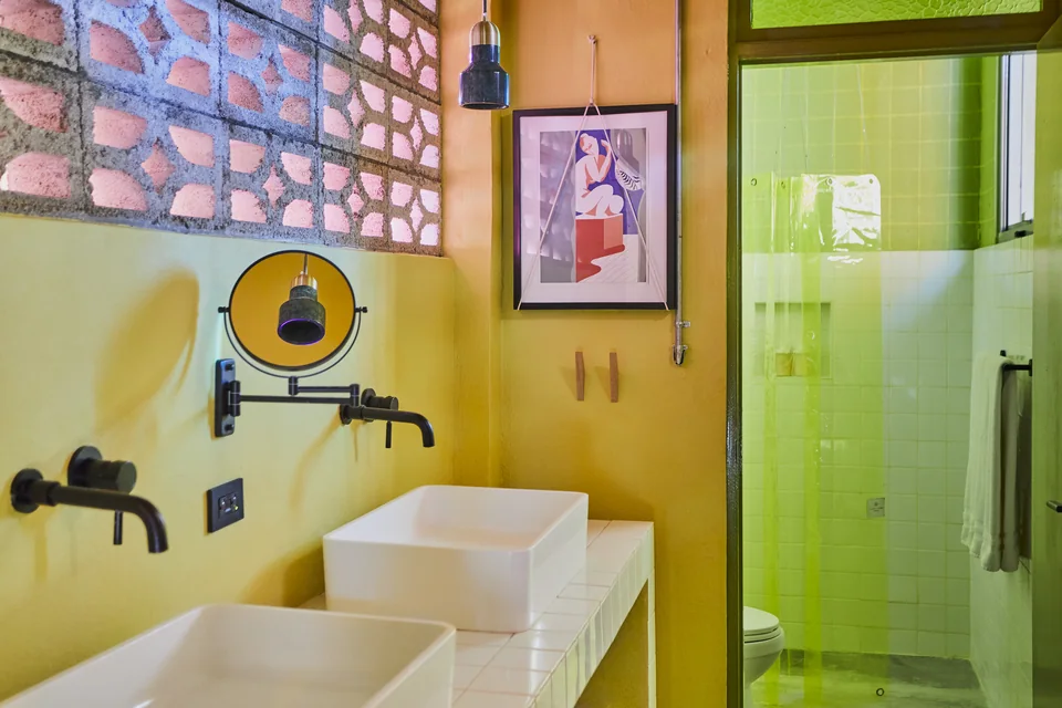 Double sinks, green tiles and patterned glass in Gloria’s bathroom
