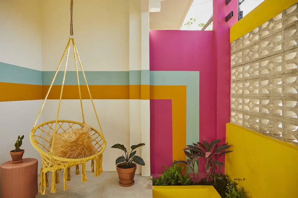 Hanging chair and colorful walls on Gloria’s terrace