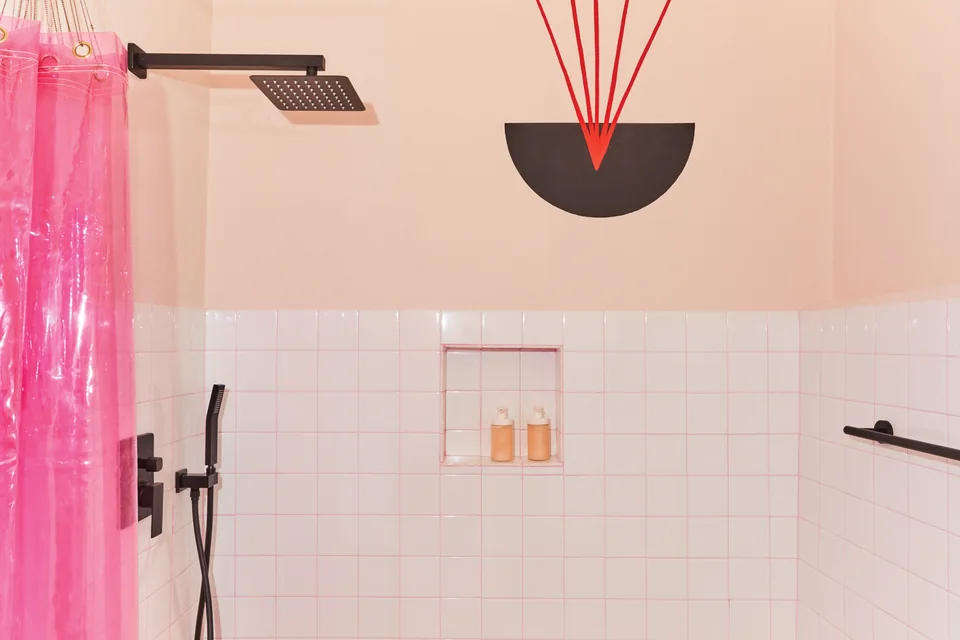 Pink translucent curtain and a rainfall shower in Grace’s designer bathroom