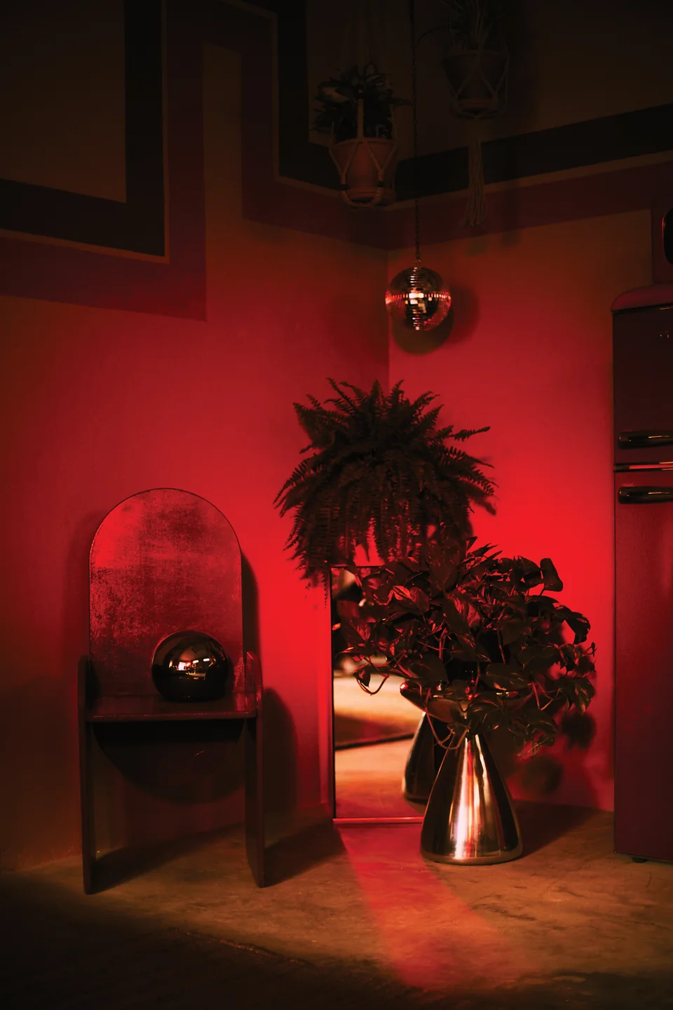 Grace’s studio lit red beneath a mirrored disco ball