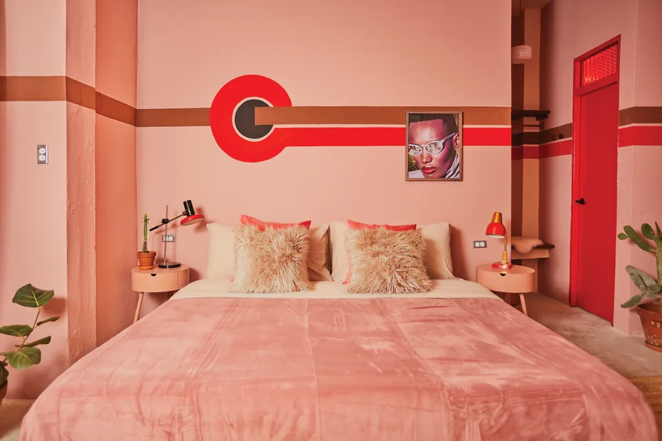 Pink velvet king bed, red stripes and a Grace Jones record in Grace