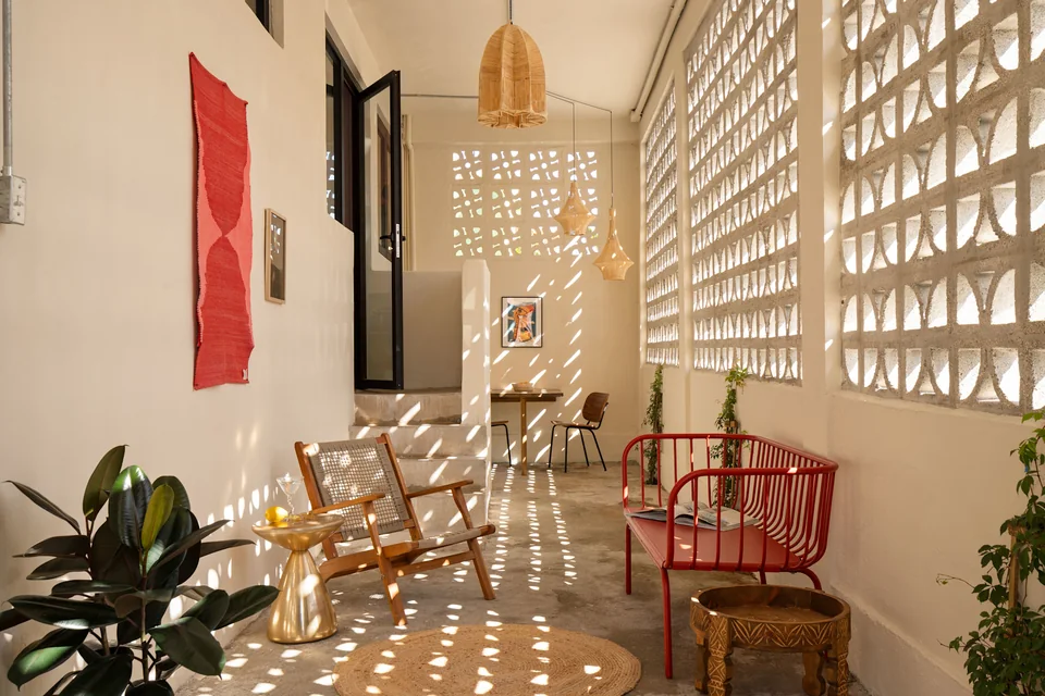 Outdoor dining and patterned sunlight on A’s covered terrace