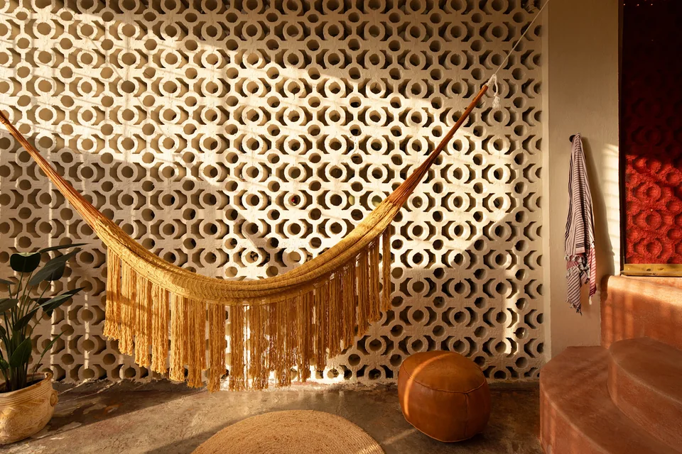 Fringed hammock against the patterned breeze-block wall on N’s terrace