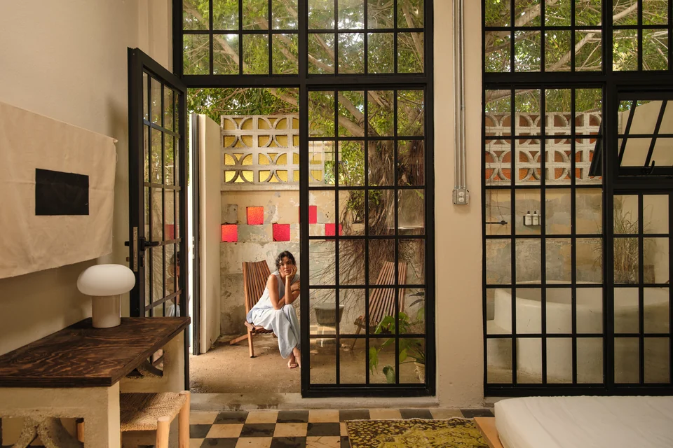 Paz 1’s black-paned glass doors opening from the studio toward the private patio