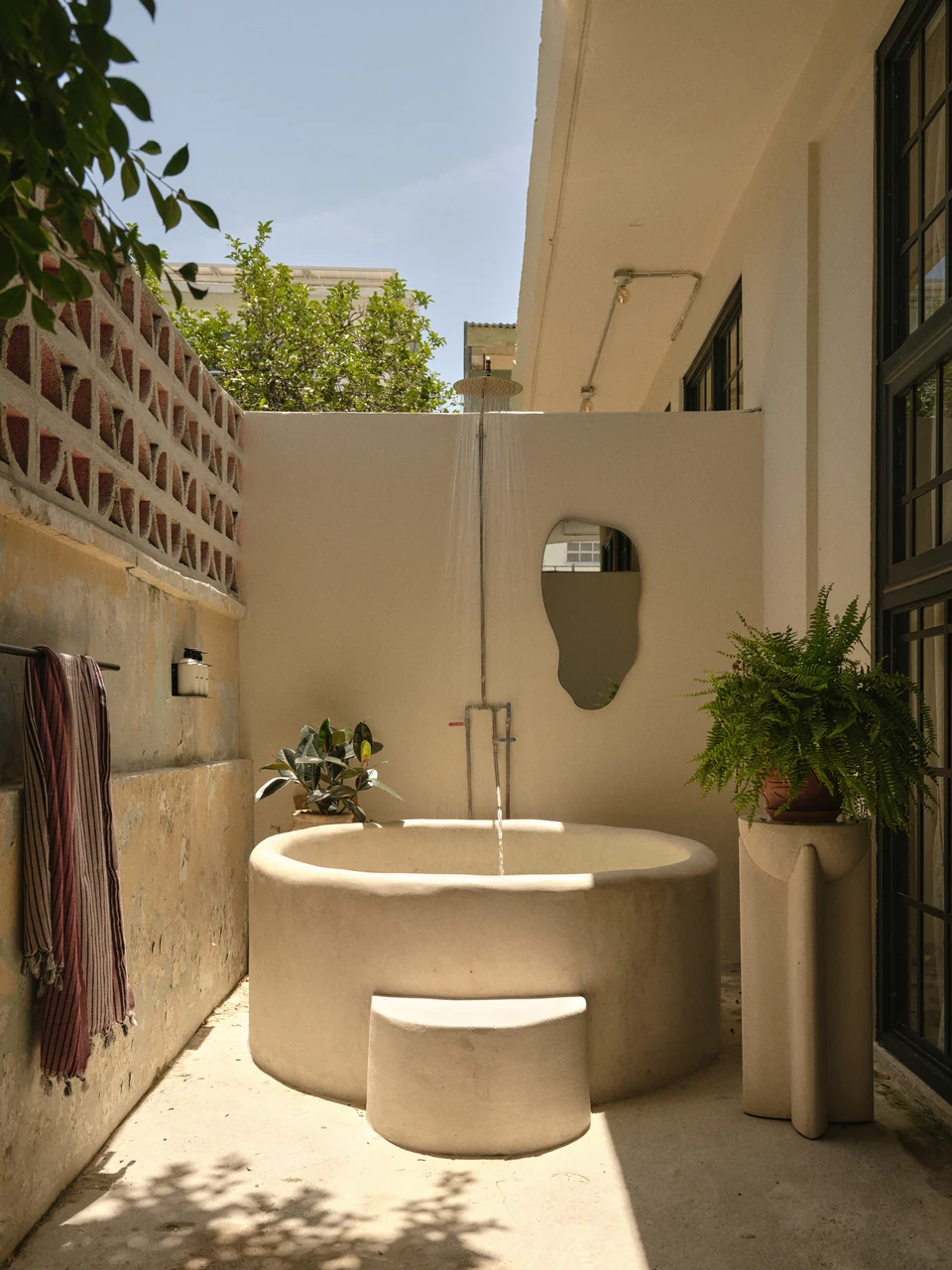 The private concrete soaking tub and outdoor shower on Paz 2’s patio