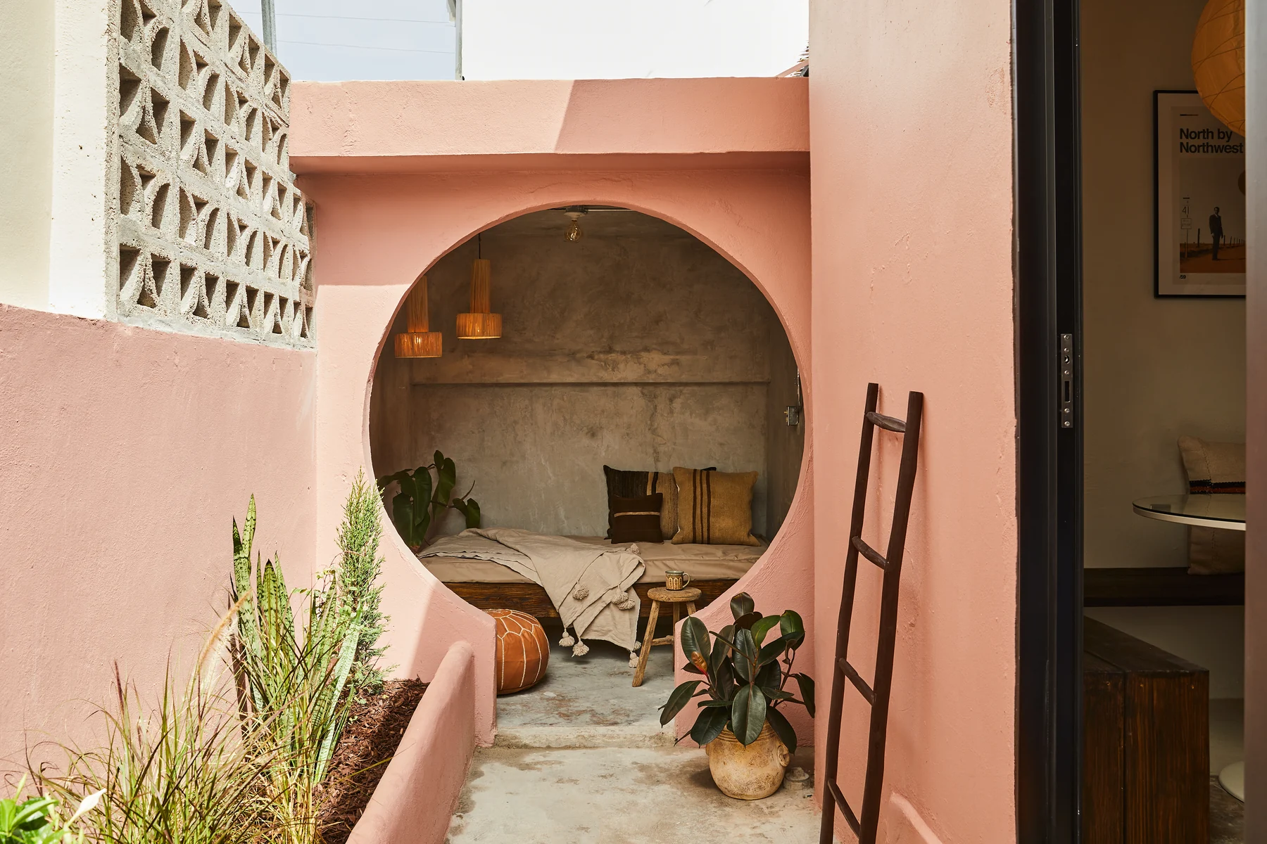 The pink circular lounge alcove and planted private terrace at Rosa 2