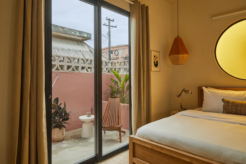 Rosa 1’s bedroom opening toward its private balcony and hammock