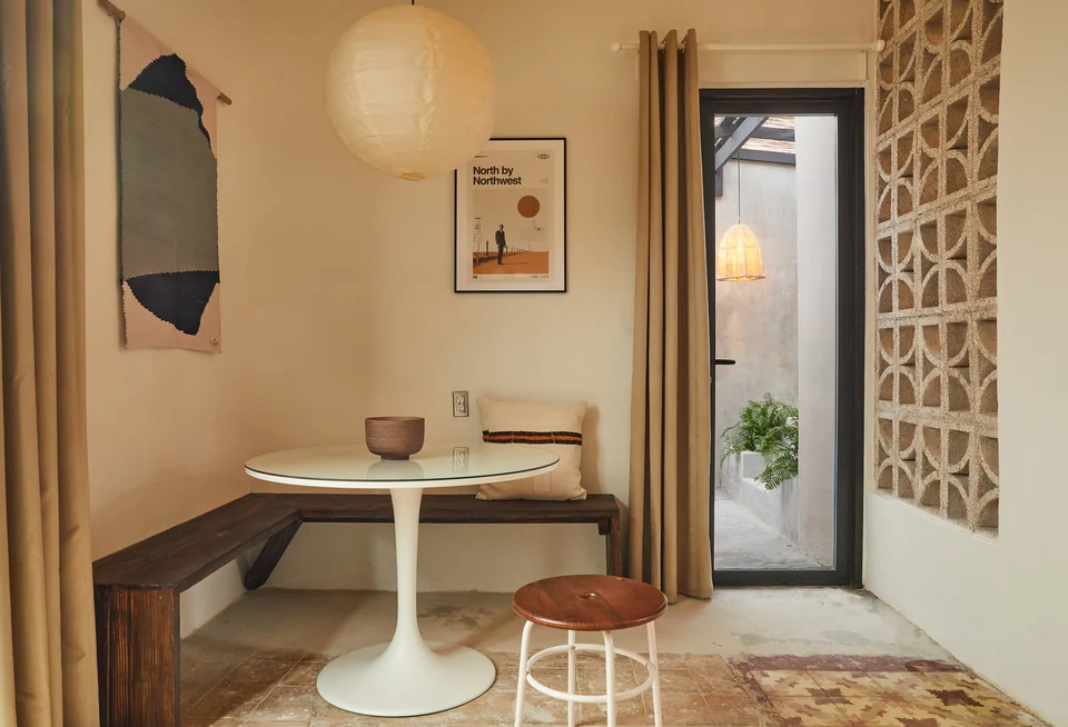 Rosa 2’s small dining table, paper pendant and patterned floor