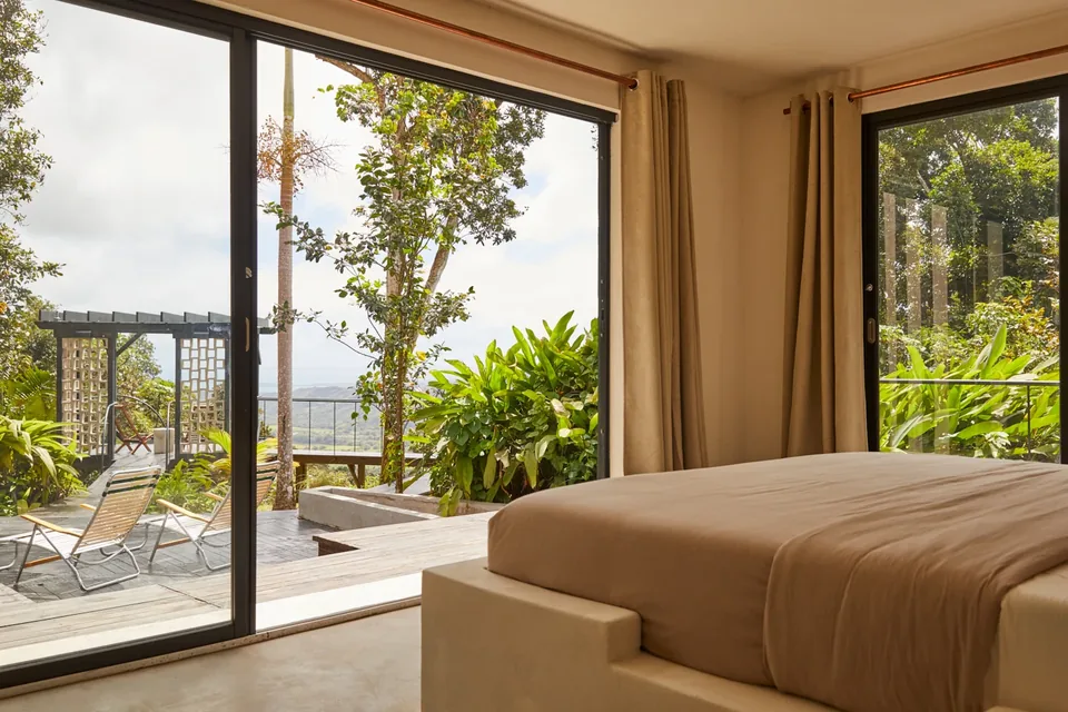 Selva’s first bedroom opening onto a balcony with rainforest views