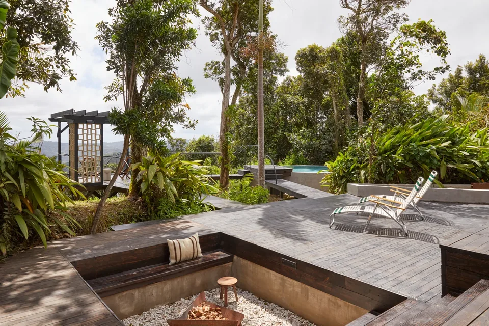 Sunken fire pit, loungers and broad timber deck at Selva
