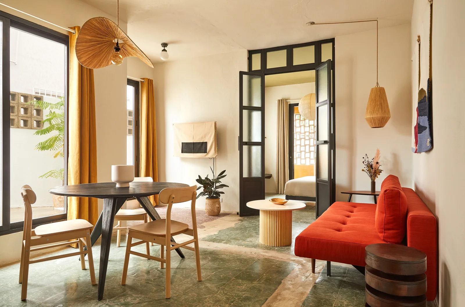 Living space, red sofa and timber dining furniture at APT.