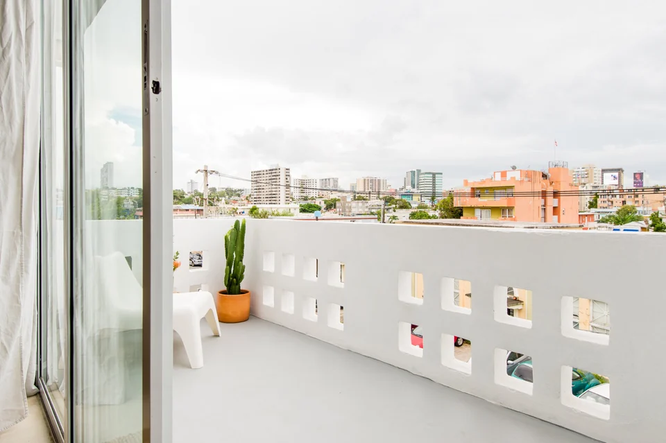 Dreamer’s private city-view balcony with patterned concrete balustrade