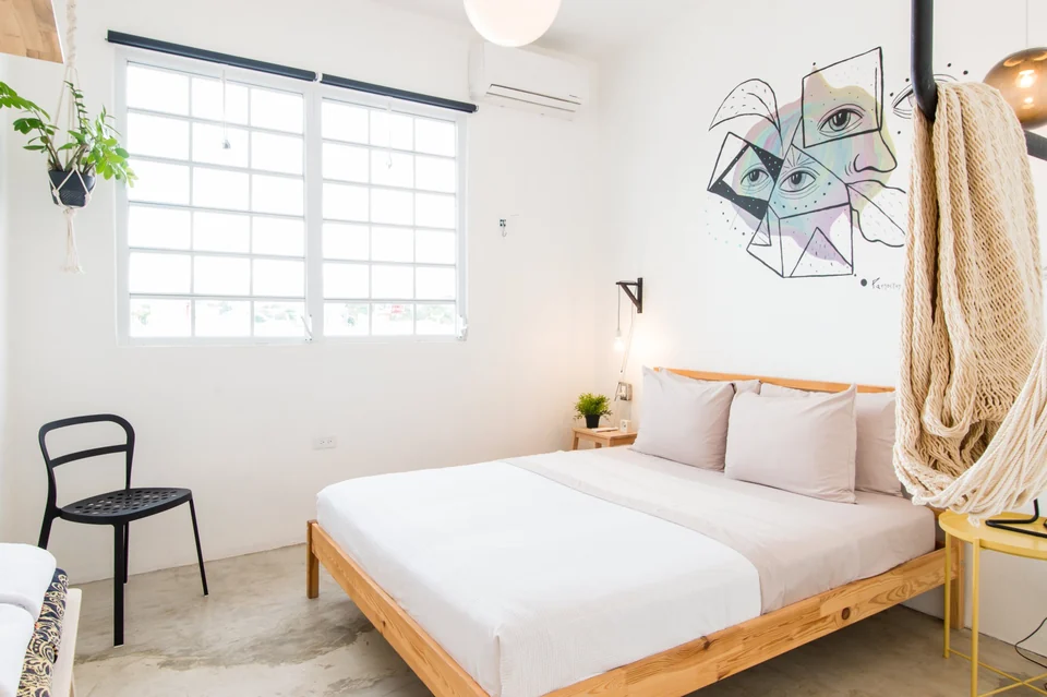 Dreamer’s second queen bedroom with geometric artwork and a hammock