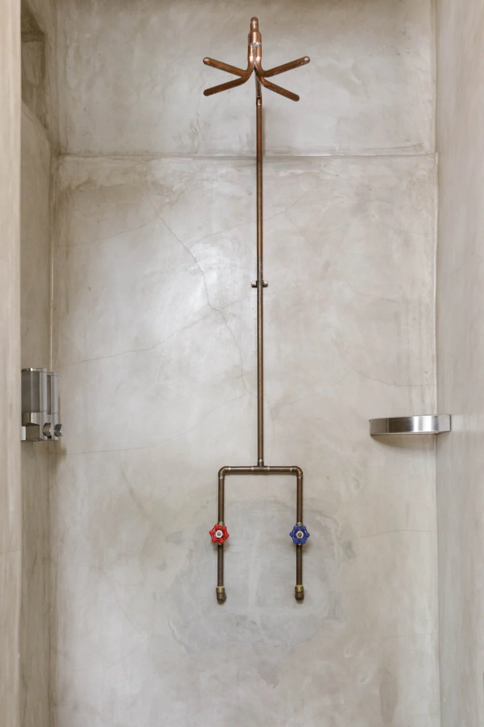 A bespoke copper shower against Lover’s polished concrete bathroom walls